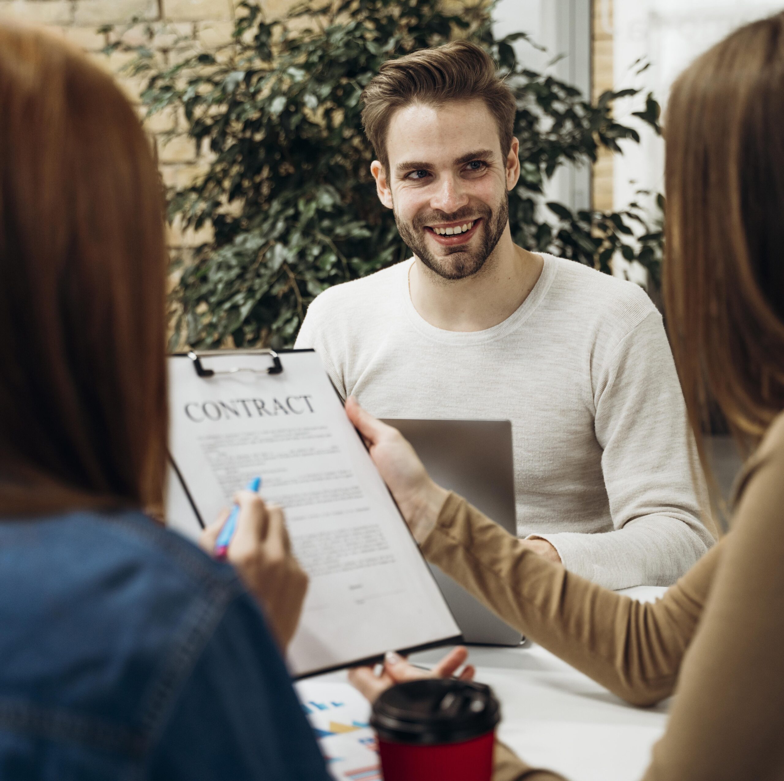 man smiling coworkers meeting